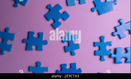 scattered puzzle pieces on colored background Stock Photo