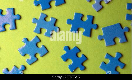 scattered puzzle pieces on colored background Stock Photo