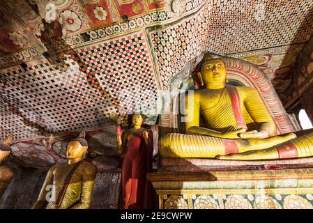 Buddha statues in Dambulla Royal Cave Temple and Golden Temple. Ancient craved rock statues, buddhist art. Famous religious place in Sri Lanka Stock Photo