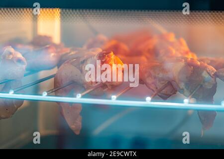 Delicious chicken wings being roasted inside oven. High quality photo Stock Photo