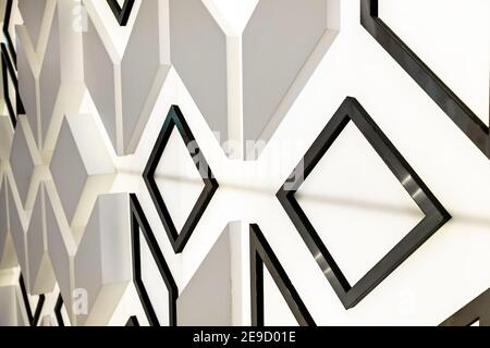 Photo of the surface of a luminous wall with three-dimensional shapes of triangles, lines and squares. Abstract design background. Stock Photo