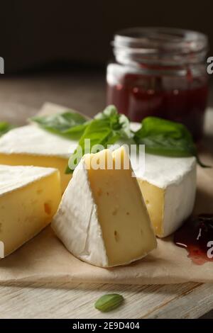 Concept of tasty eating with camembert and jam on cutting board Stock Photo