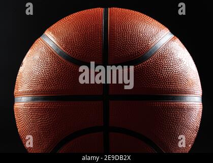 Basketball ball close up on dark black background Stock Photo