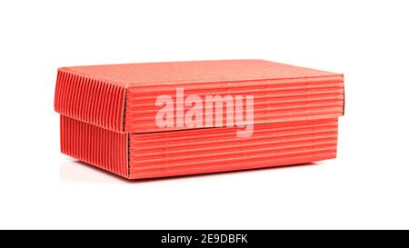 Red closed corrugated cardboard box isolated on white. Valentine's Day gift packaging concept Stock Photo