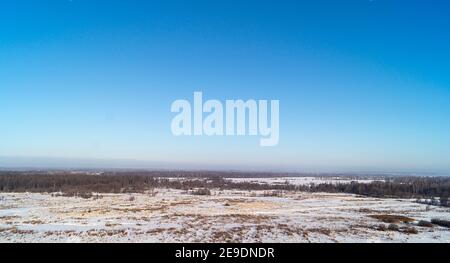 The Winter landscape with plain on background blue sky. Beautiful type with horizon on land in Russia Stock Photo