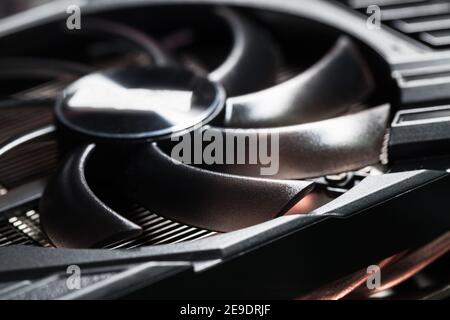 New shiny black plastic GPU cooler, close-up photo with selective focus. This fan is mounted on a video card to cool the GPU Stock Photo