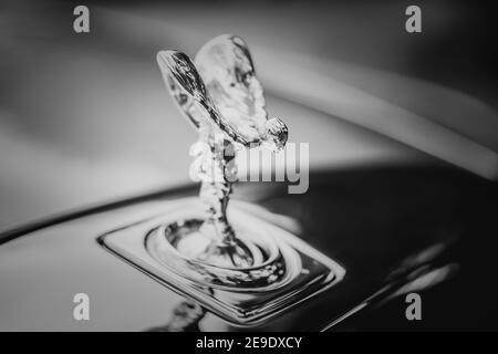 Rolls Royce Phantom classic car silver flying lady bonnet ornament statue in black and white close up macro of iconic luxury shiny figure Stock Photo