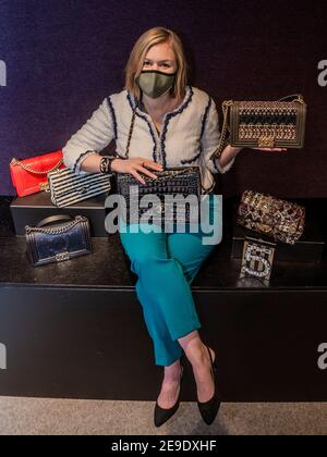 London, UK. 4th Feb, 2021. A Black Alligator Jumbo Double Flap Bag, Chanel, c. 2010-11, est£8,000 - 12,000 held (centre) by Meg Randell, Head of Department, Bonhams Designer Handbags & Fashion, with a selection of other bags - Preview of Bonhams' The Chanel Collection: Online Auction dedicated to the luxury French fashion house and offering more than 200 pieces ranging from clothing and accessories to handbags and jewellery at Bonhams Knightsbridge. The Sale will be a timed online auction running for 11 days from 5 to 16 February inclusive. Credit: Guy Bell/Alamy Live News Stock Photo