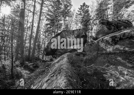 Ancient weathered megalithic granite rock formation with cave and breakthrough in Bavarian forest near Thurmansbang, Germany Stock Photo