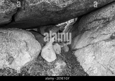 Ancient weathered megalithic granite rock formation with cave and breakthrough in Bavarian forest near Thurmansbang, Germany Stock Photo