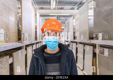 A man in a hardware store. Sells tiles. Selective focus. People. Stock Photo