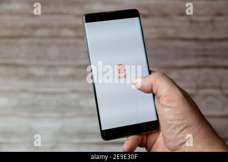 A hand holding a Mobile phone or cell phone with the Hive smart home app on screen Stock Photo