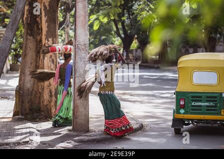 Bengaluru, India - June 08, 2020. Indian women in colorful sarees carrying a bundle on her head. India, Bengaluru Stock Photo