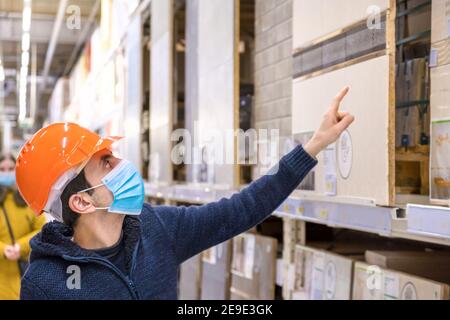 A man in a hardware store. Sells tiles. Selective focus. People. Stock Photo