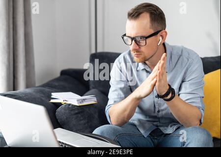 Intelligent businessman lost in thinks about solving a complex business problem, developing, engineering. Freelancer using laptop for working from Stock Photo