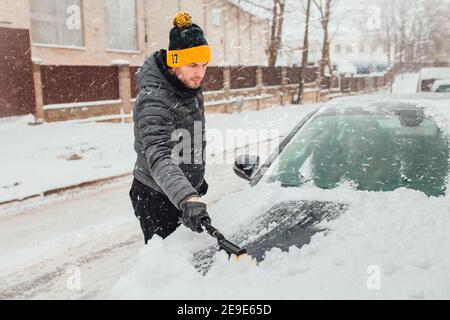 The car is covered with snow in a blizzard - a cyclone and heavy snowfall Stock Photo