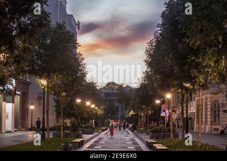 BELGRADE, SERBIA - AUGUST 26, 2020: People walking and sitting, on the pedestrian street of Obilicev Venac during a sunner evening sunset, in Stari Gr Stock Photo