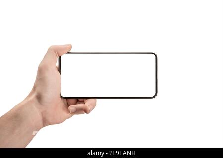 mockup phone horizontal. Hand Holding The Black Smartphone and Modern Frameless Design. Isolated man left hand holding black horizontal cellphone phon Stock Photo