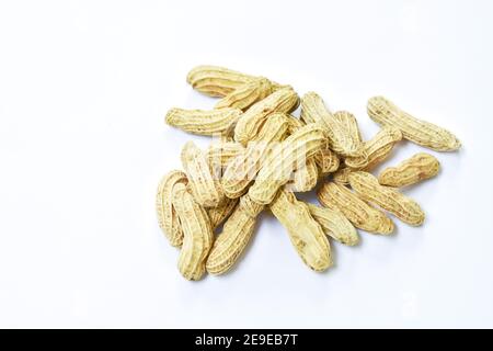 boiled peanuts with peel on white background Stock Photo