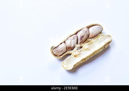 boiled peanuts with peel on white background Stock Photo