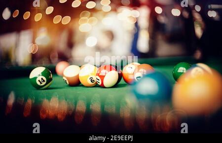 Colorful billiard balls on a green billiard table. Gambling game of Billiards. Stock Photo