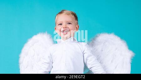 Little angel boy making funny face. Valentines angels. Cute cupid boy. Stock Photo