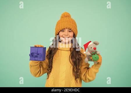 happy new 2020 year. cute santa mice toy gift. small girl hold mouse toy and present box. child knitted clothes play with toy rat. toy shop for kids. christmas is here. xmas favorite winter holiday. Stock Photo