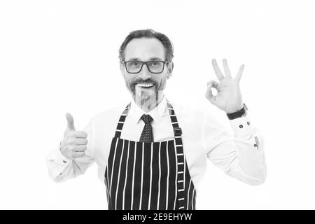 best and perfect. best mature male cook isolated on white. confident chef in apron. perfect cooking in kitchen. bearded man baker in glasses. catering business. thumb up and ok gesture. be the best. Stock Photo