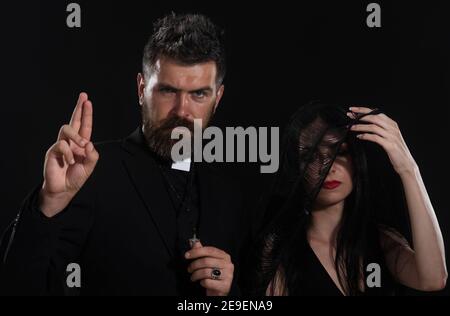 Funeral. Priest Blessing gesture. Pastor with woman-widow. Stock Photo
