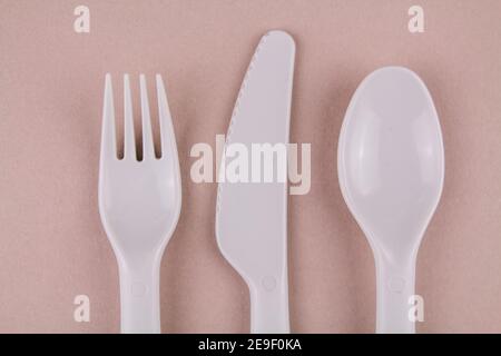 a set of plastic dishes spoon fork gray knife on the table reusable eco-friendly Stock Photo