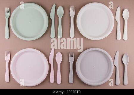 a table setting in a restaurant for four persons with a plate spoon fork knife Stock Photo