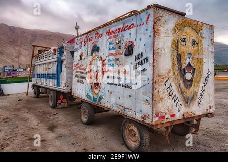 Ocona, Peru - August 18, 2010: A ramshackle old style circus truck painted by hand seen parked in a gas station on the road to Arequipa Stock Photo