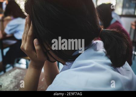 Students taking exam with stress in school classroom Stock Photo