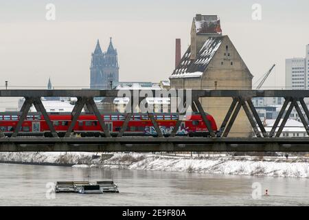 01 February 2021, Saxony-Anhalt, Magdeburg: A train drives over a bridge over the Elbe. Buildings of the state capital can be seen in the background. Photo: Klaus-Dietmar Gabbert/dpa-Zentralbild/ZB Stock Photo