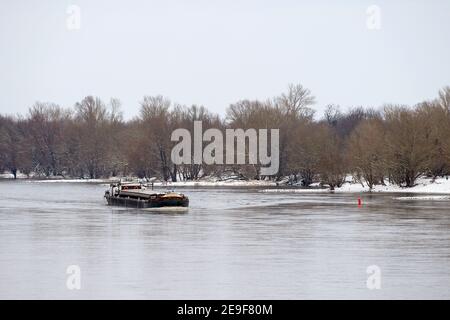 01 February 2021, Saxony-Anhalt, Magdeburg: A barge sails on the Elbe past the wintry Herrenkrug Park. Photo: Klaus-Dietmar Gabbert/dpa-Zentralbild/ZB Stock Photo