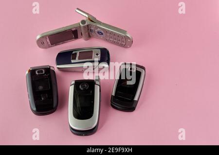 broken mobile phones, recycling technology, early 2000s on pink background  and copy space Stock Photo - Alamy