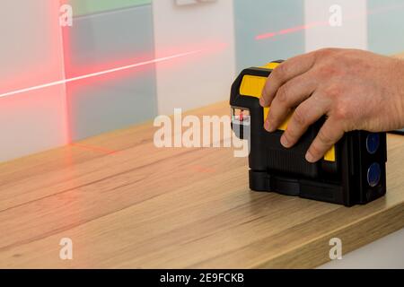 Electronic laser pointing straight lines. Checking angles and setting points while taking measurements Stock Photo