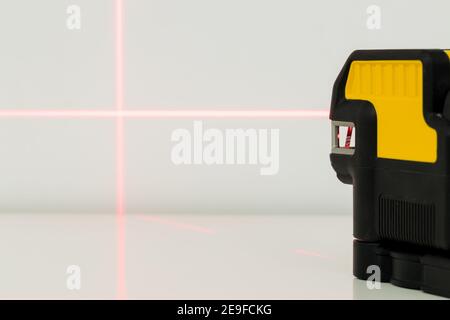 Electronic laser pointing straight lines. Checking angles and setting points while taking measurements Stock Photo