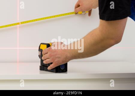 a specialist makes measurements using an electronic laser measuring the angles Stock Photo