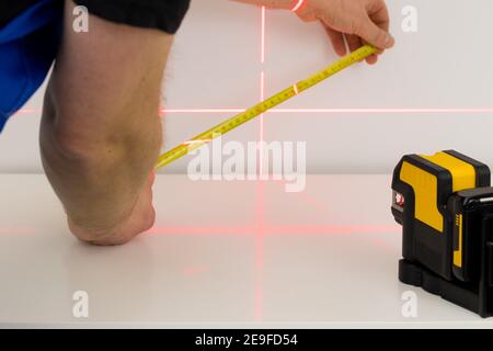 a specialist makes measurements using an electronic laser measuring the angles Stock Photo