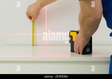a specialist makes measurements using an electronic laser measuring the angles Stock Photo