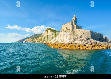The imposing Church of St. Peter and the Doria Castle on the rocky peninsula at the entrance to Porto Venere Italy on the Ligurian Coast. Stock Photo