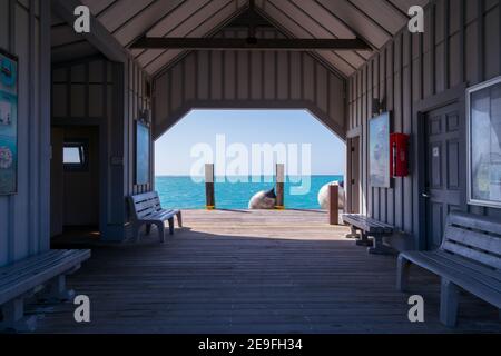 Ocean pier with a wooden walk in front in tropical paradise on a sunny day. Dry Tortugas, Florida. Stock Photo