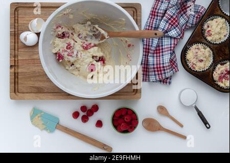Making raspberry muffins in the kitchen Stock Photo