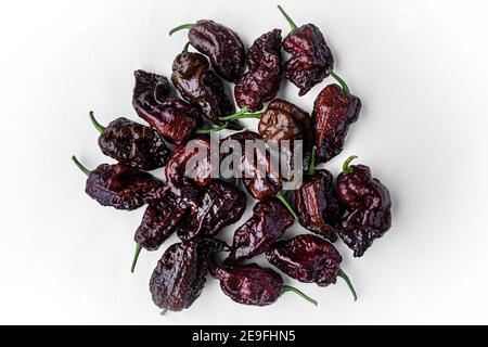Photograph of Chocolate Carolina Reaper Peppers on White Background Stock Photo