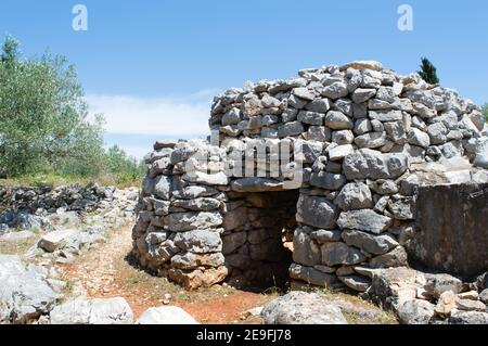 Small stone house and shelter with entrance built in the technique of dry wall construction, UNESCO intangible heritage, in Croatia Stock Photo