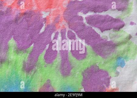 Pastel tie dye, a handmade pattern on a cotton t-shirt. Close-up, top view. DIY concept, handicrafts, original everyday clothes, fabric dyeing techniq Stock Photo