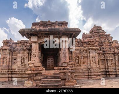 Bagalakote, Karnataka, India - November 7, 2013: Pattadakal temple complex. Monumnetal sculpted entrance of brown stone Viruipaksha temple under blue Stock Photo