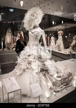 Bridal dress designer admiring his own Flower Bomb design at the