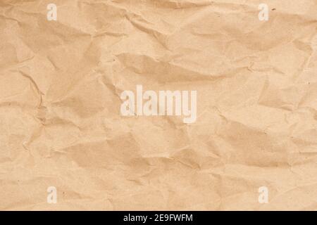 Crumpled brown paper texture perfect for background structure. Packaging material with rough wrinkles. The grunge textured surface is vintage Stock Photo